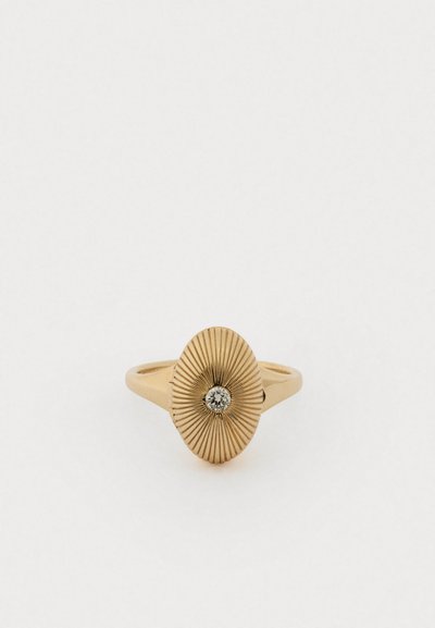 Bague en or avec un design ovale texturé présentant des lignes rayonnantes, accentuée par un diamant centré. Bande lisse.
