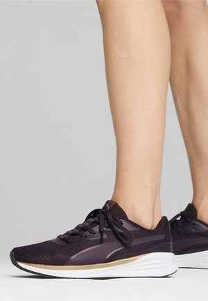 Zapatillas deportivas moradas con parte superior de malla, cordones a juego, suela de goma y acentos reflectantes. Diseñadas para la comodidad y el rendimiento.