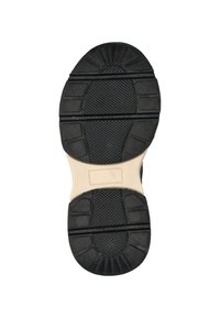 Zwarte rubberen schoenzool met een textuurpatroon voor grip, met een beige tussenzool. Gecontourde vorm met gedefinieerde noppen en ribbels voor tractie.