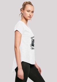 White short-sleeve T-shirt with a relaxed fit. Features a graphic of a kitten behind sunglasses with the text "YOU GOT THIS, KITTEN."