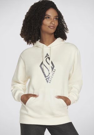Cremefarbener Hoodie mit Kordelzug, der ein diamantenförmiges Grafikdesign in dunklen Farben zeigt. Er hat eine frontale Tasche und gerippte Bündchen an den Handgelenken.
