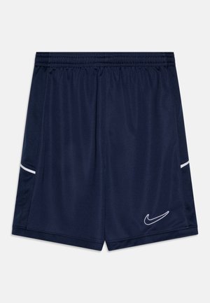 Tamsiai mėlyni sportiniai šortai, pagaminti iš lengvos medžiagos, su elastiniu juosmeniu ir baltais akcento juostelėmis šoninėse dalyse. Rodyklės Nike logotipas.