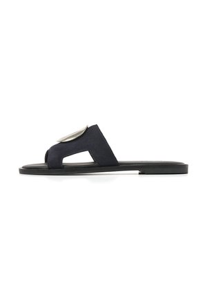 Black flat slide sandal with wide suede strap featuring a large silver oval buckle, and an open toe design.