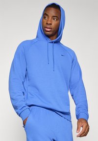 Blue hooded sweatshirt in soft material, featuring a kangaroo pocket, ribbed cuffs, and a small logo on the chest.