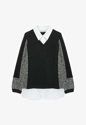Pull noir à col en V avec col et ourlet de chemise blancs, avec des manches texturées à motifs noirs et blancs.