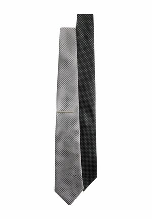 Two silk men's ties, one light gray and one black, both with small geometric patterns, the gray tie has a silver tie clip.