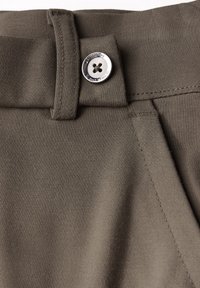 Olive green trousers featuring a smooth texture, a stitched waistband, and a metal button with a five-holed design for fastening.