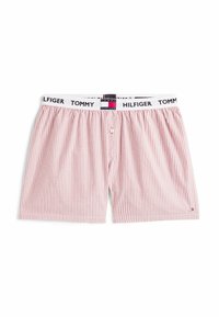 Pantaloni boxer a righe rosse e bianche con vita elasticizzata e il logo "Tommy Hilfiger". Chiusura frontale con bottone, in morbido cotone.