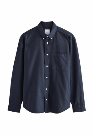 Námornícky modrá košeľa na gombíky vyrobená z bavlny. Obsahuje jednu náprsníkovú kapsu, dlhé rukávy a klasický golier s bielymi gombíkmi.