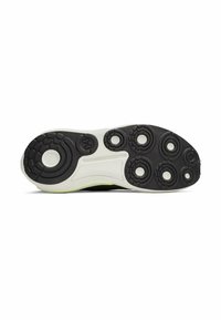 Black and white athletic shoe sole with textured grip patterns and circular accents. Features a prominent logo and a pop of neon color along the side.