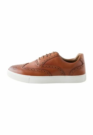 Brown leather sneaker with brogue detailing and white rubber sole, lace-up closure, and low-top design.