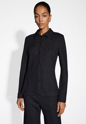 Schwarzer, strukturierter Blazer mit Kragen, langen Ärmeln und Knopfverschluss. Verfügt über einen dezenten Glanz und funkelnde Details auf der gesamten Oberfläche.
