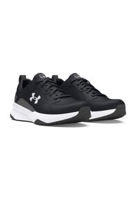 Zapatillas deportivas negras con un upper sintético liso, entresuela blanca y suela de goma negra texturizada. Presentan un acento gris y cordones.