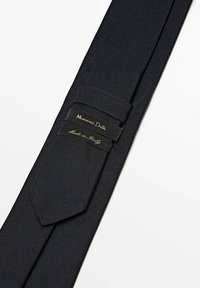 Navy tie made of textured fabric featuring a pointed end, with two labels: "Massimo Dutti" and "Made in Italy" in gold lettering.