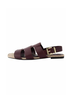 Burgundy leather sandal featuring three wide straps, a rear buckle, and a braided jute-like sole with a black edge. Flat design, open toe.
