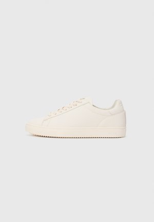Low-top off-white sneaker with lace-up closure and ridged sole, shown in side profile on plain light background.