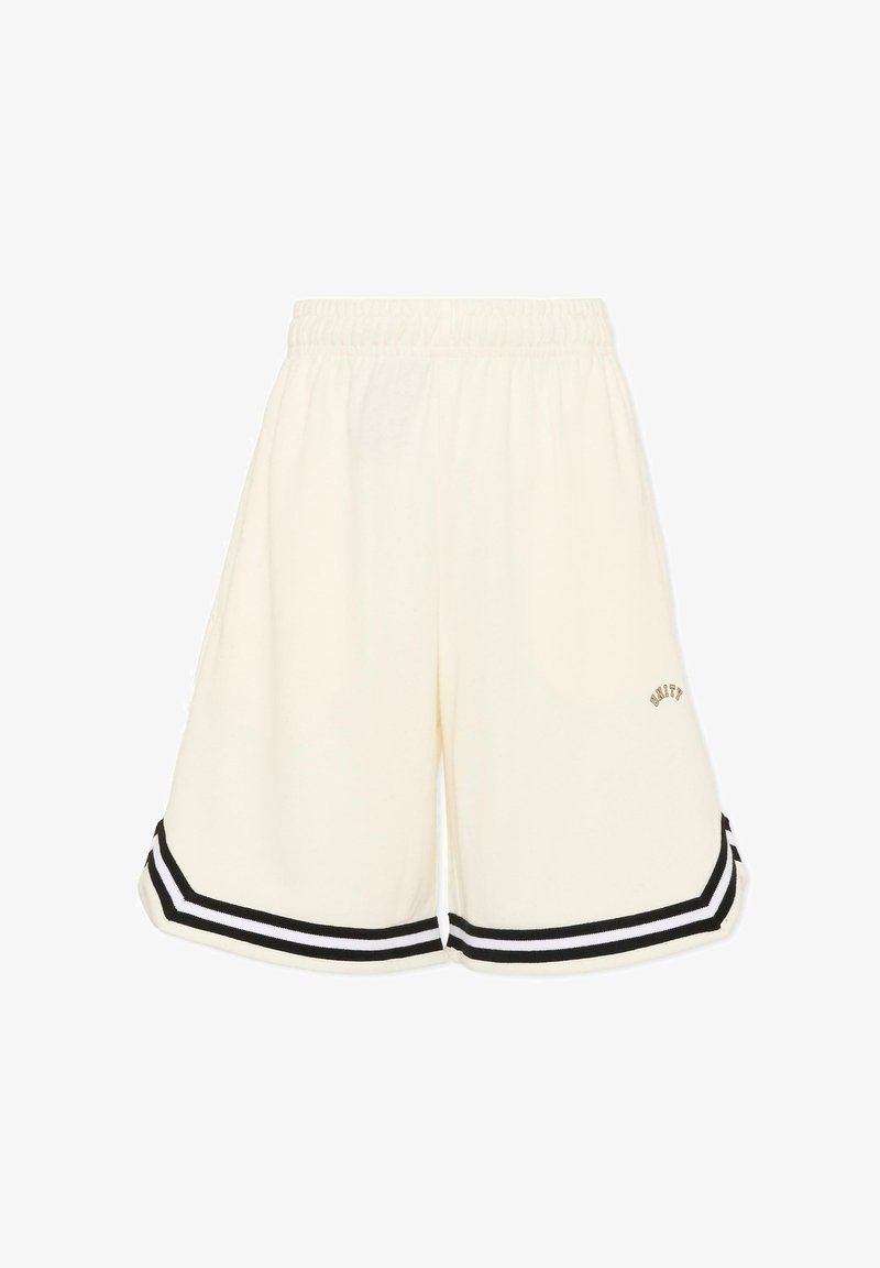 Shorts amples couleur crème avec ceinture élastique, bordure rayée noir et blanc à l'ourlet, et petit logo "UNITY" sur la jambe gauche.