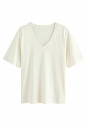 T-shirt con scollo a V in morbido tessuto bianco sporco. Maniche corte, vestibilità comoda, texture liscia, senza motivi o dettagli visibili. Design semplice.