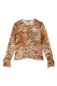 Long-sleeved blouse in a translucent fabric featuring a tan and black tiger stripe pattern, with tie accents at the sleeve cuffs.