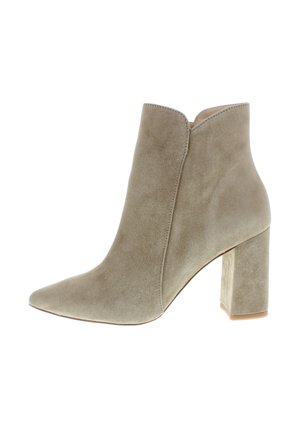 Beige suede ankle boot with pointed toe and block heel, side slit at top edge, isolated on white background.