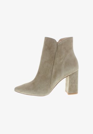 Beige suede ankle boot with pointed toe and block heel, side slit at top edge, isolated on white background.