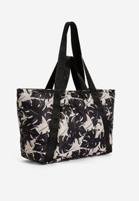 Borsa a spalla imbottita in bianco e nero con motivo floreale, grande capacità e spallacci neri stampati resistenti.