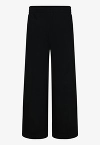 Calças largas pretas com um cós elástico, feitas de um tecido macio, apresentando uma textura suave e sem padrões ou detalhes visíveis.