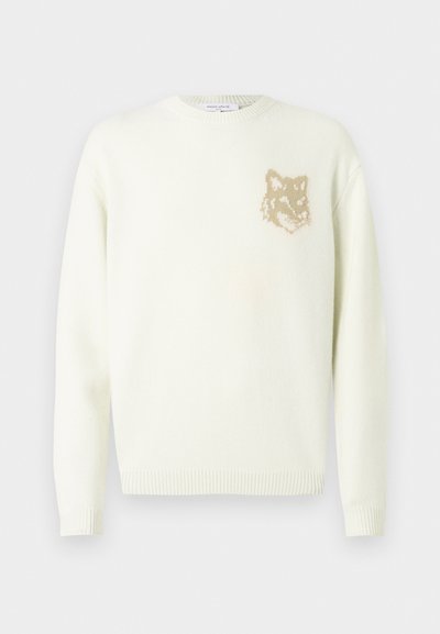 Világos krém színű crewneck pulóver hosszú ujjakkal, bal mellrészen egy kis bézs színű rókafej grafikával, bordás mandzsettákkal és aljjal.