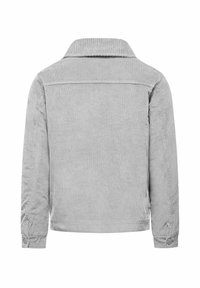 Camicia in velluto a coste grigia con colletto, maniche lunghe e polsini con bottoni. Presenta una texture a coste verticali su tutta la superficie.