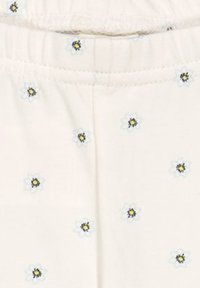 Crème-kleurige stof met verspreide bloemenpatronen en kleine zwarte en gele bijen. Elasticaat voor rek en comfort.