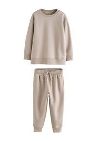 Beige cotton sweatshirt with round neckline, ribbed cuffs, and matching tapered sweatpants with drawstring waist and side pockets.
