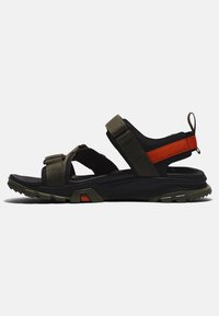 Sport sandals with a black and olive green design. Features adjustable straps, durable sole with traction, and orange accents on the heel.