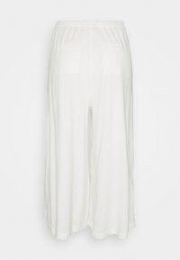 Białe, lekkie kuloty z elastycznym pasem, wyposażone w dwie tylne kieszenie i luźny, swobodny krój. Gładka tekstura i przewiewny materiał.