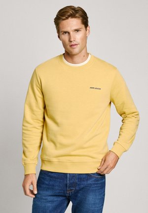 Kollane crewneck-sweatshirt, mis on valmistatud pehmest kangast, ribitud varrukate ja alläärega, rinnal on väike "Pepe Jeans" logo.