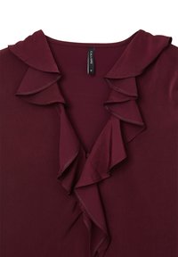 Blouse bordeaux avec col à volants et détails à l'avant, taille petite, tissu en mélange coton ou polyester.