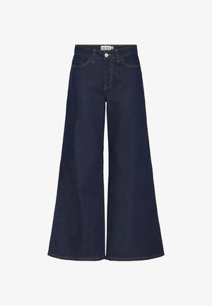 Tumesinised laia säärega teksad kõrge vöökohaga, tehtud denimist. Omavad kontrastsete õmblustega ja ees nupuga sulgemist.