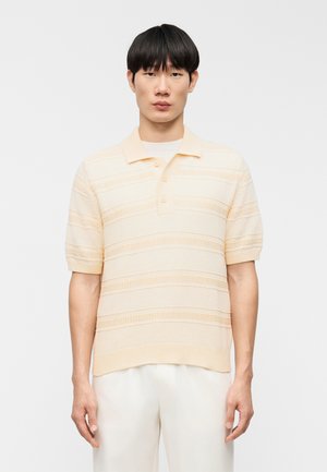 Textúrované krátky rukáv polokošeľa v svetložltej farbe s horizontálnymi pruhmi, placket s tromi gombíkmi a rebrovaným golierom a manžetami. Mäkký pletený materiál.
