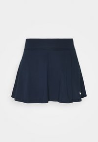 Falda corta deportiva de color azul marino con una cinturilla ancha y pequeño logo blanco de Nike cerca del dobladillo en el lado derecho.