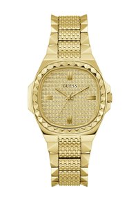 Reloj dorado con una esfera cuadrada, adornada con cristales y con una pulsera texturizada que presenta acentos de pirámide. Logo de la marca visible.