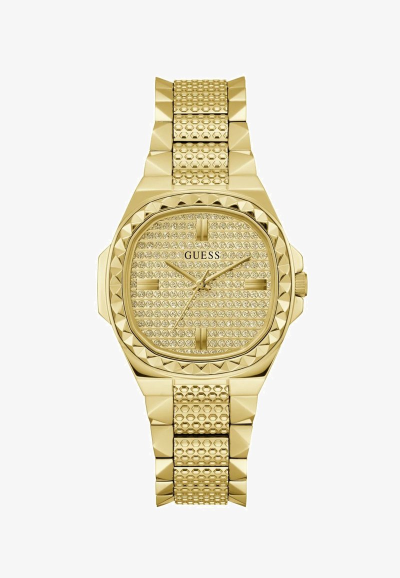 Zlati pogled z kvadratno podobo, okrašen s kristali in z teksturiranim zapestjem z naglavnimi akcenti. Prikazana blagovna znamka.