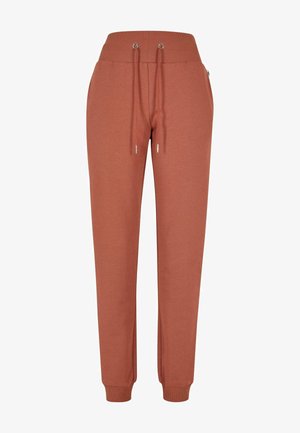Rustoransje joggebukser laget av myk stoff, med ribbestrikket midjebånd, justerbare snorer og tettsittende mansjetter ved anklene.