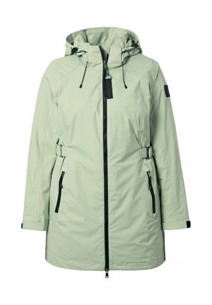 Světle zelený dámský dlouhý plášť do deště s kapucí, černým předním zipem, nastavitelnými bočními pásky a kapsami na zip.