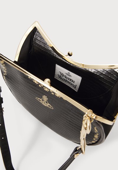 Black faux crocodile leather handbag with a gold-tone frame, featuring a branded interior label and decorative gold accents on the exterior.