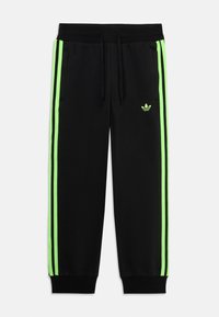 Zwarte sweatpants met neon groene zijstrepen en een bijpassend logo. Voorzien van een elastische tailleband met veters en geribde boorden.