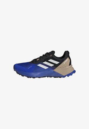 Adidas Terrex trail running shoes featuring a blue and black mesh upper, three white stripes, beige accents, and textured rubber sole.