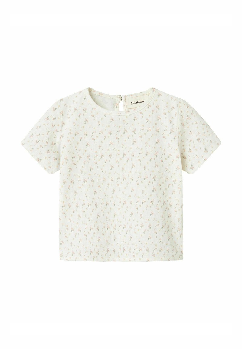 Top a maniche corte in tessuto crema chiaro, caratterizzato da una delicata stampa floreale nei toni del rosa e del verde. Scollatura rotonda con chiusura a bottoni sul retro.