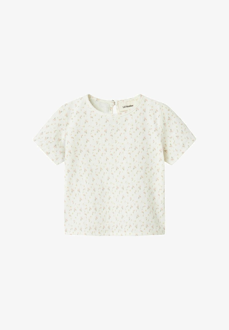 Top a maniche corte in tessuto crema chiaro, caratterizzato da una delicata stampa floreale nei toni del rosa e del verde. Scollatura rotonda con chiusura a bottoni sul retro.