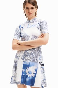 Short-sleeve dress with a ribbed texture, featuring blue graphic prints, including flowers and text. A-line silhouette with side slits.
