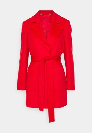 Red belted coat with a lapel collar, long sleeves, two front pockets, and a smooth texture. Designed with a tailored fit and minimalist style.