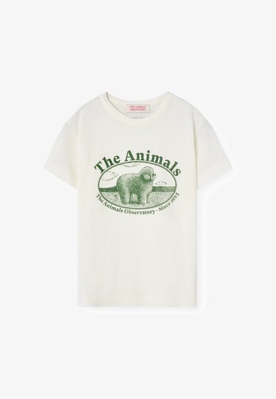Camiseta de algodón, color crema, con un gráfico verde de una oveja que incluye el texto "The Animals Observatory" y un borde redondeado. Manga corta.